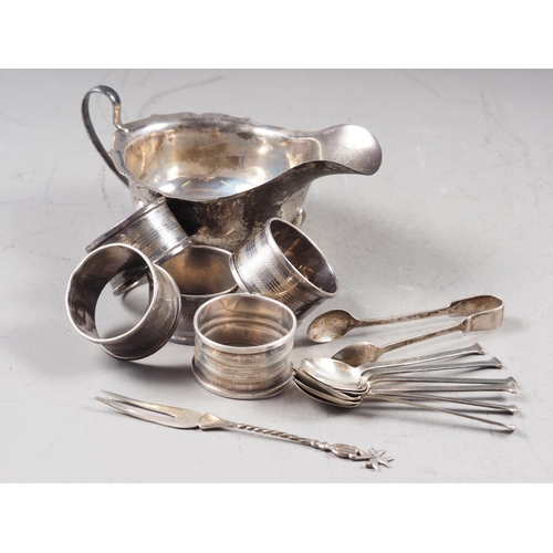 338 - A set of six silver coffee spoons, five silver napkin rings, a white metal pickle fork, a pair of si... 