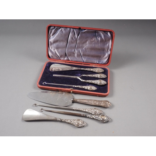 341 - A shoe horn, button hook and glove stretchers with silver handles, in fitted case, two similar butto... 