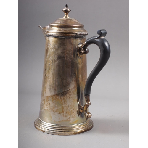 350 - A silver hot water jug of plain design with ebonised handle, on circular stepped base, 8