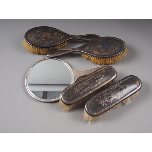 351 - Four matching silver mounted and tortoiseshell-backed dressing table brushes and a silver-backed dre... 