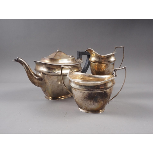 355 - A silver three-piece teaset of plain design with gadrooned border, 32.6oz troy approx