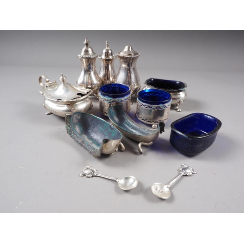 358 - A pair of silver salt cellars with shaped rims (one split), a similar mustard pot, two silver pepper... 