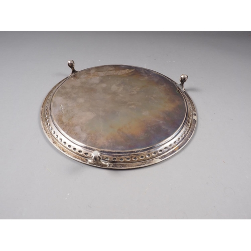 359 - A silver circular card tray with engraved presentation decoration and gadrooned border, on three bal... 