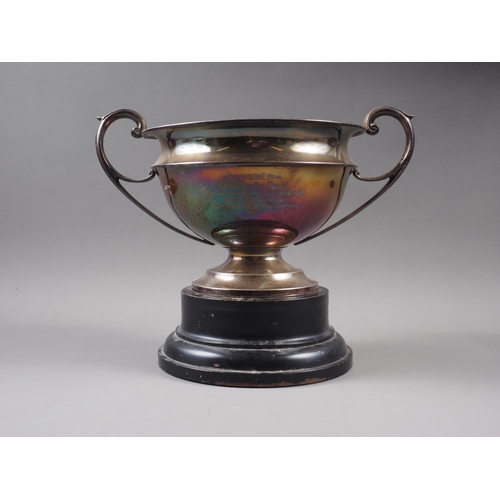 360 - A silver two-handled trophy with engraved presentation decoration, on circular base, 6 1/4