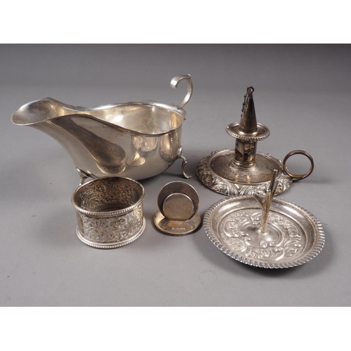 363 - A silver sauce boat with shaped rim, a silver napkin ring, a silver menu holder, a silver ring stand... 