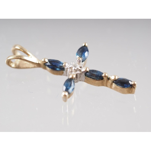 386 - A pair of yellow metal sapphire and diamond ear studs, and a matching cross