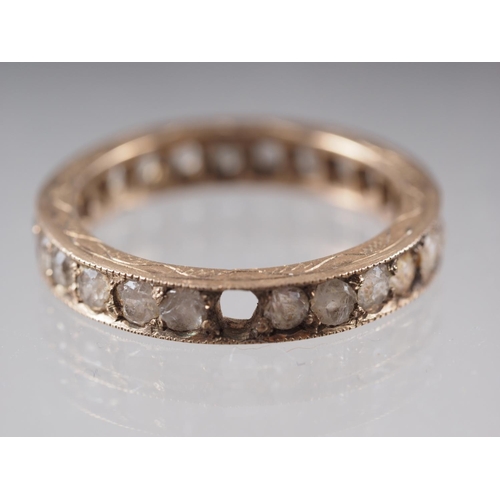 396 - A yellow metal and blue stone eternity ring, a similar yellow metal and clear stone set eternity rin... 