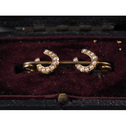 406 - A yellow metal and seed pearl set bracelet with horseshoe design, in box, two similar bar brooches, ... 