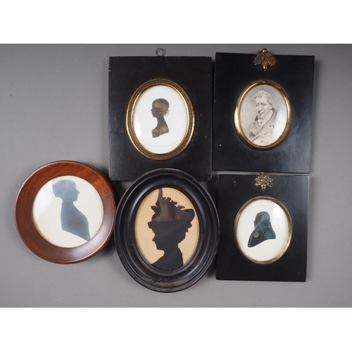 460 - An early 19th century silhouette of a woman, in circular mohogany frame, a similar early 20th centur... 