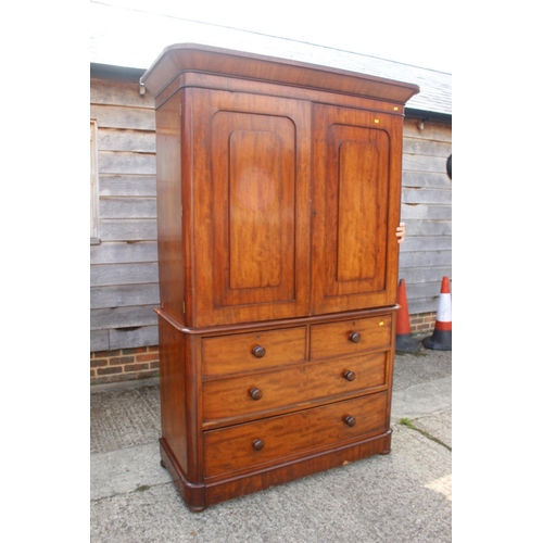 551 - A late Victorian figured mahogany linen press, the upper section fitted trays and shelves, enclosed ... 