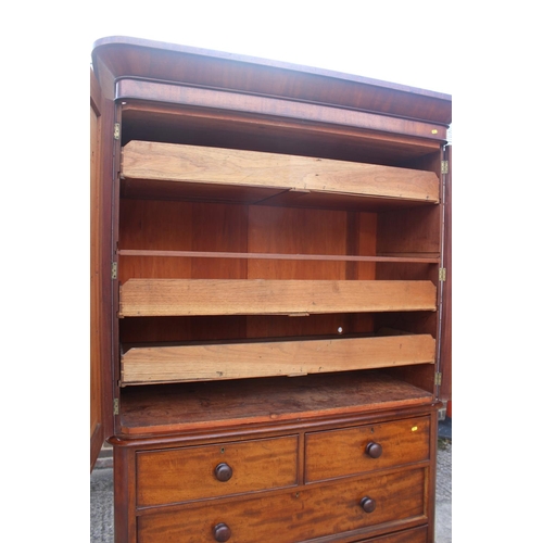 551 - A late Victorian figured mahogany linen press, the upper section fitted trays and shelves, enclosed ... 