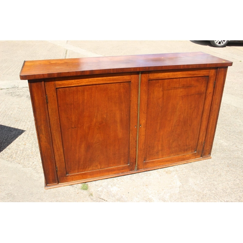 552 - A late 19th century mahogany linen cupboard, enclosed two panel doors, on block base, 66