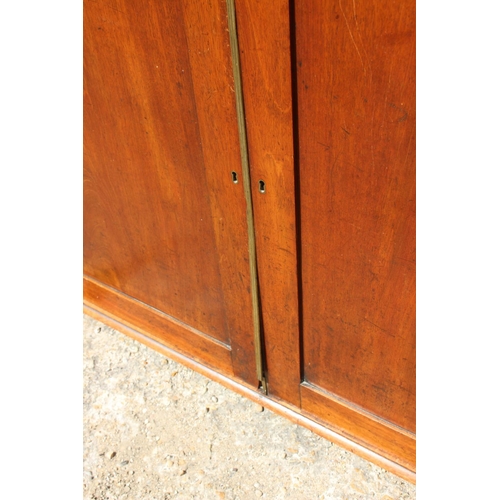 552 - A late 19th century mahogany linen cupboard, enclosed two panel doors, on block base, 66