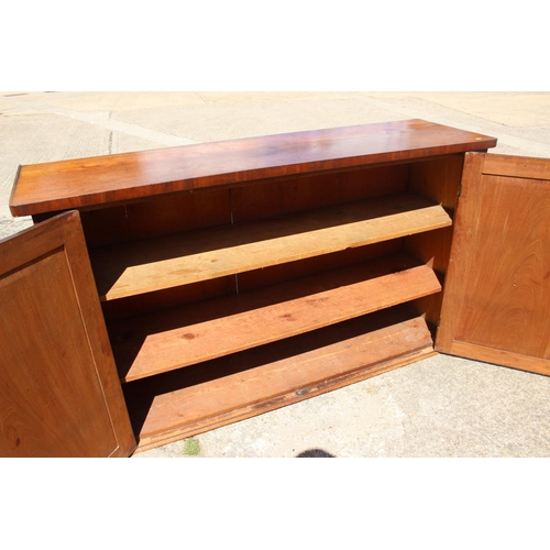 552 - A late 19th century mahogany linen cupboard, enclosed two panel doors, on block base, 66