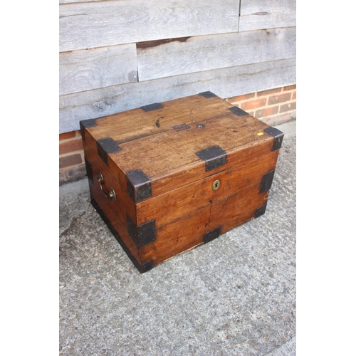 553 - A 19th century iron bound teak strong box/chest with brass carry handles, 26