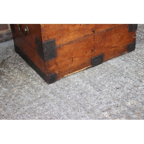 553 - A 19th century iron bound teak strong box/chest with brass carry handles, 26