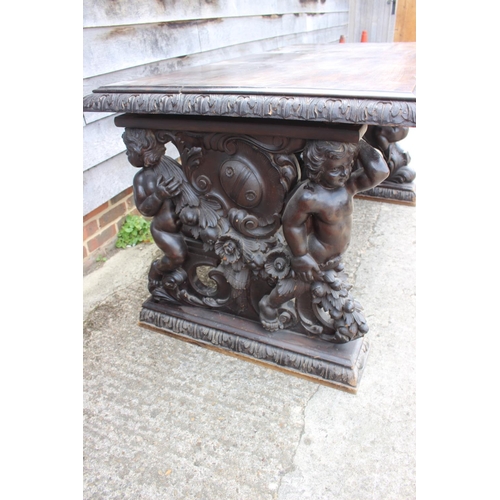 557 - A mid Victorian carved walnut centre table of 17th century design, figure and scroll panel end suppo... 