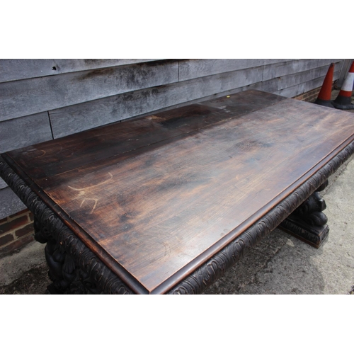 557 - A mid Victorian carved walnut centre table of 17th century design, figure and scroll panel end suppo... 