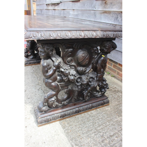 557 - A mid Victorian carved walnut centre table of 17th century design, figure and scroll panel end suppo... 