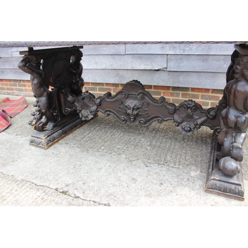 557 - A mid Victorian carved walnut centre table of 17th century design, figure and scroll panel end suppo... 