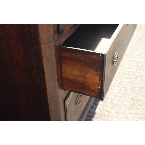 563 - A late 18th century oak and mahogany ledge back sideboard with lift-up top, fitted three short drawe... 