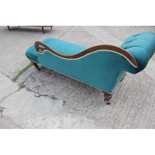 584 - A late 19th century mahogany framed chaise longue, upholstered in a turquoise velour, on turned and ... 