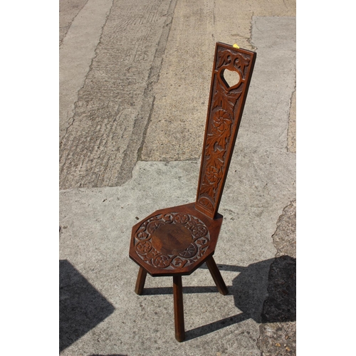 588 - A 19th century Welsh spinning chair with carved back and seat panel, on four supports