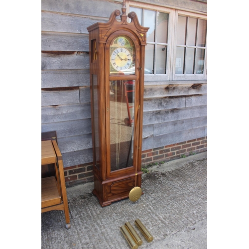 594 - An oak long case clock with eight-day striking and chiming movement, enclosed glazed door, 77