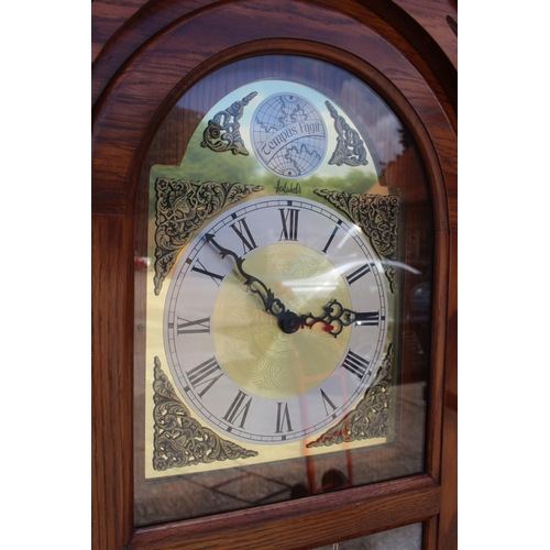 594 - An oak long case clock with eight-day striking and chiming movement, enclosed glazed door, 77