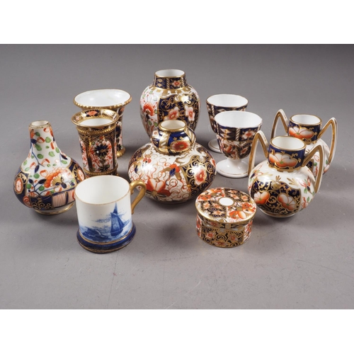 68 - A group of Royal Crown Derby bone china Imari decorated miniature items, including a pair of two-han... 