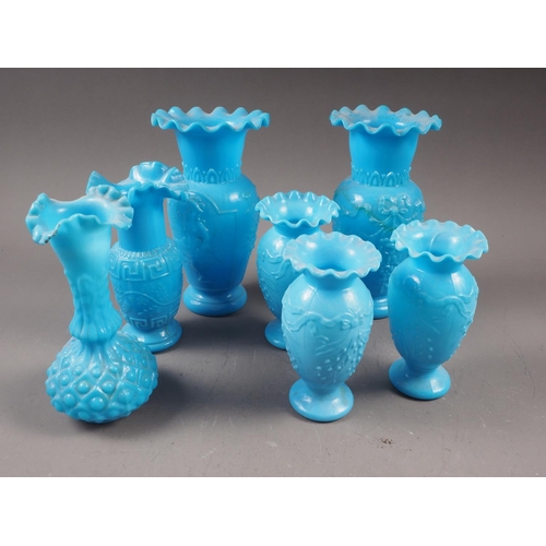 81 - Three milk blue moulded glass vases with relief swag and sprig decoration, 5 1/4