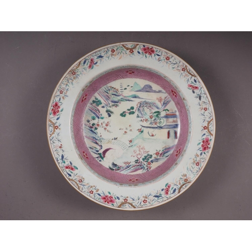 93 - A Chinese famille rose bowl with landscape decoration and floral borders, 14 1/2