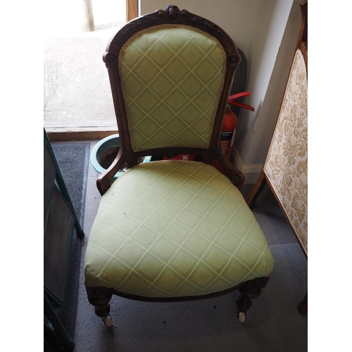 547 - A Victorian carved walnut low seat occasional chair, upholstered in a green fabric