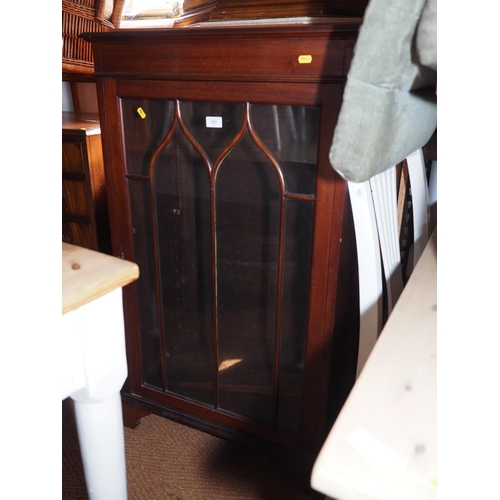 567 - A mahogany display cabinet, enclosed Gothic lattice glazed door, on bracket feet, 26