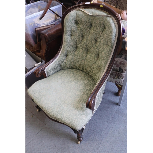 576 - A Victorian carved walnut showframe tub seat armchair, upholstered in a green figured brocade, on ca... 