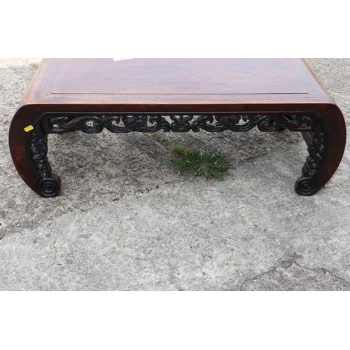 575 - A Chinese carved hardwood low table, on scroll end supports, 37