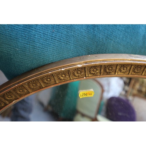 596 - A 19th century oval gilt framed wall mirror, and another gilt framed oval wall mirror