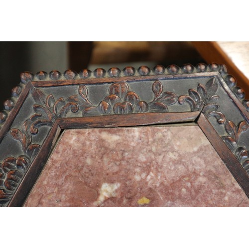 555 - A Chinese carved hardwood hexagonal topped plant stand, inset hardstone, on six carved cabriole supp... 