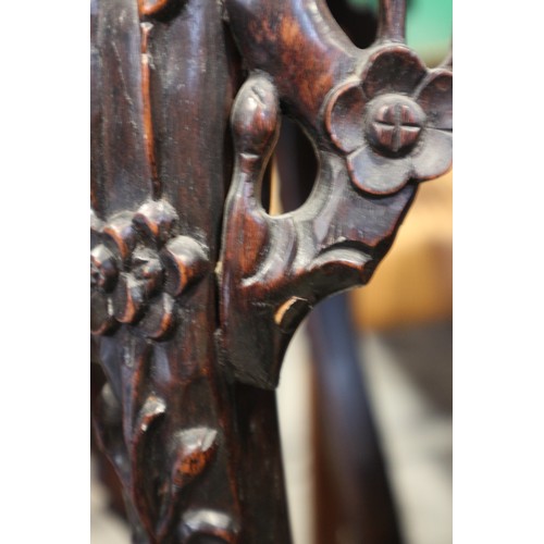 555 - A Chinese carved hardwood hexagonal topped plant stand, inset hardstone, on six carved cabriole supp... 