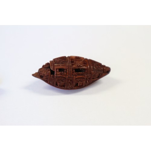 105 - A Chinese Hediao carved nut, formed as boat with figures, with retractable windows and verse to base... 