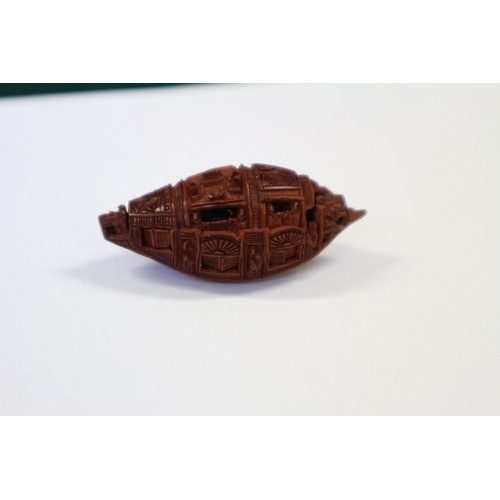 105 - A Chinese Hediao carved nut, formed as boat with figures, with retractable windows and verse to base... 