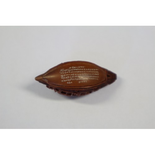 105 - A Chinese Hediao carved nut, formed as boat with figures, with retractable windows and verse to base... 