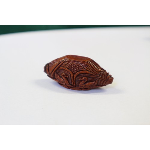 105 - A Chinese Hediao carved nut, formed as boat with figures, with retractable windows and verse to base... 