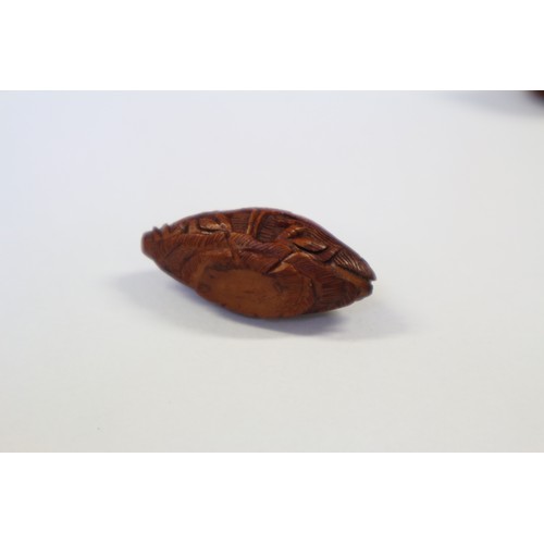 105 - A Chinese Hediao carved nut, formed as boat with figures, with retractable windows and verse to base... 