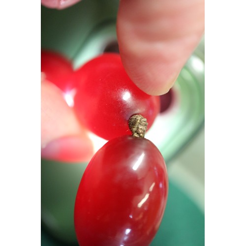 368 - An Art Deco cherry amber Bakelite graduated bead necklace, the largest oval bead 22mm wide, total we... 