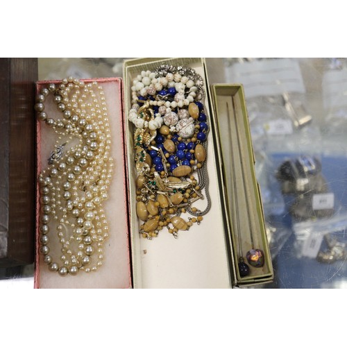 404 - A quantity of costume jewellery, including brooches, two pins, shirt studs, various white metal and ... 