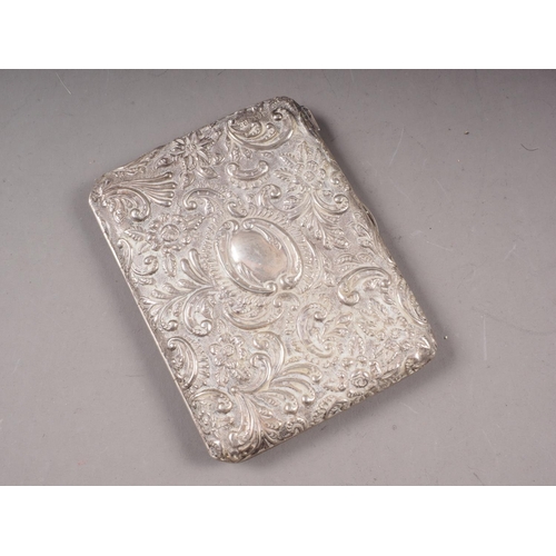 144 - A silver cigarette case with embossed scrolled and floral decoration, 4 1/2