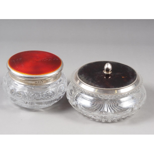 154 - A cut glass powder jar, with silver and red guilloche enamel lid, and a similar dressing table jar, ... 