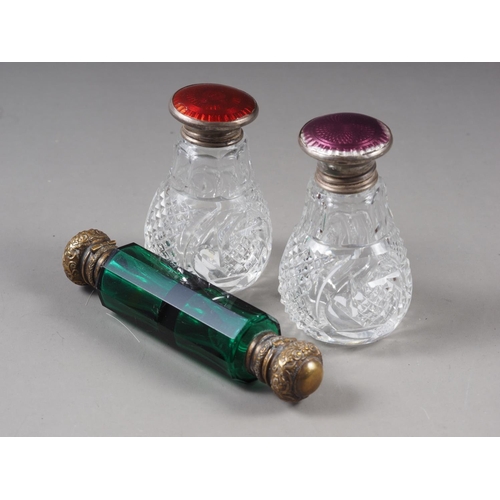 157 - Two silver end guilloche enamelled cut glass scent bottles, and a green glass and brass mounted doub... 