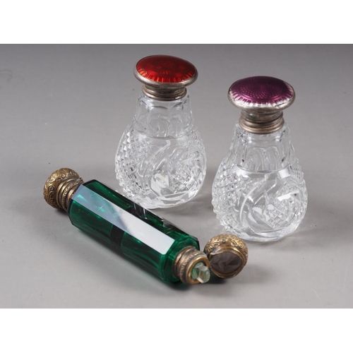 157 - Two silver end guilloche enamelled cut glass scent bottles, and a green glass and brass mounted doub... 